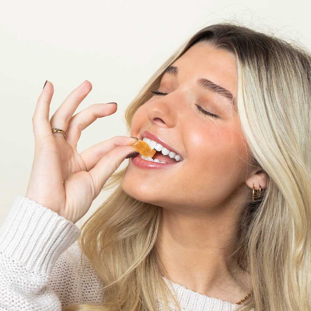 Woman eating VAYU gummies